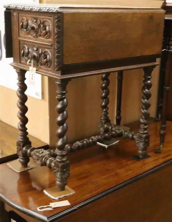 A late 19th century Flemish carved oak drop flap work table W.60cm